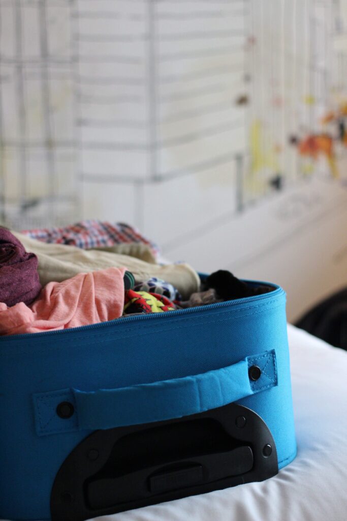 Blue Suitcase filled with folded clothes