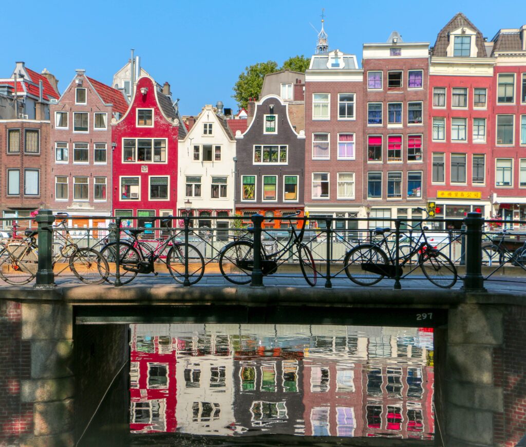 View of Amsterdam buildings with bicycles in foreground.