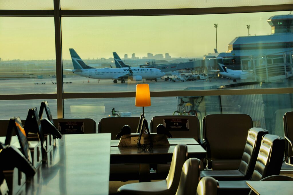Airport lounge with large window view of plane on runway