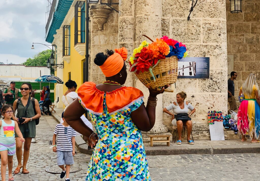 Colourful ladiy carrying basket of colourful flowers