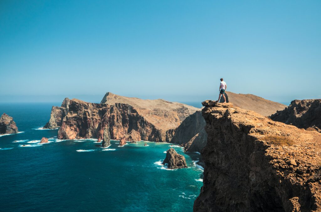 Man on cliff looking out to sea in Madeira