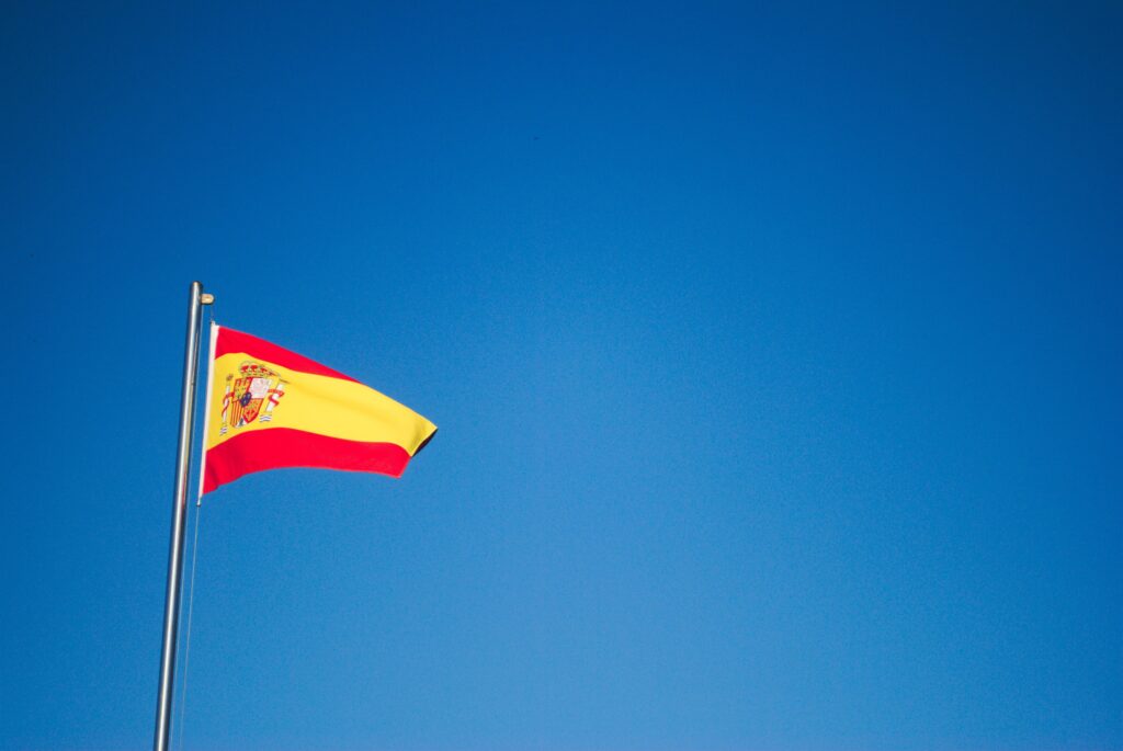 Spanish flag against clear blue sky