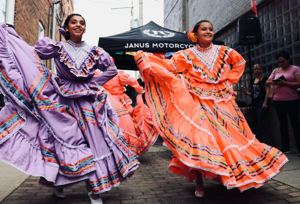 Two spanish ladies in traditional dress in street to represent Madrid and Barcelona
